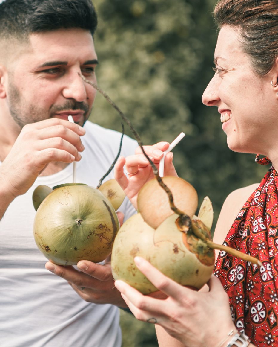 A couple enjoying a king coconut beverage at Amuna Ayurveda & Wellness Retreat, Sri Lanka